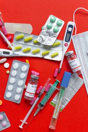 Medical supplies and medications displayed on a red background, emphasizing healthcare essentials. — 2020 vision: Looking at