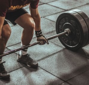A focused weightlifter prepares to lift a heavy barbell in an indoor gym setting. — A Complete Guide to Fitness in Spring TX
