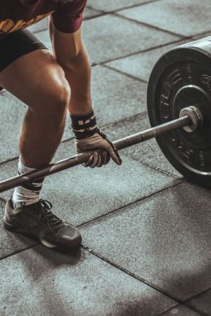 A focused weightlifter prepares to lift a heavy barbell in an indoor gym setting. — A Complete Guide to Fitness in Spring TX