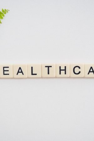 Healthcare word spelled with Scrabble tiles next to a green fern leaf on a white background. — Best Way To Test Your Sexual H
