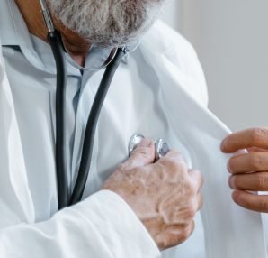 Close-up of a doctor adjusting a stethoscope while in a medical consultation. — Can Prenatal Screening Detect Down Syndrome i