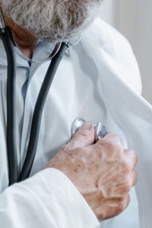 Close-up of a doctor adjusting a stethoscope while in a medical consultation. — Can Prenatal Screening Detect Down Syndrome i