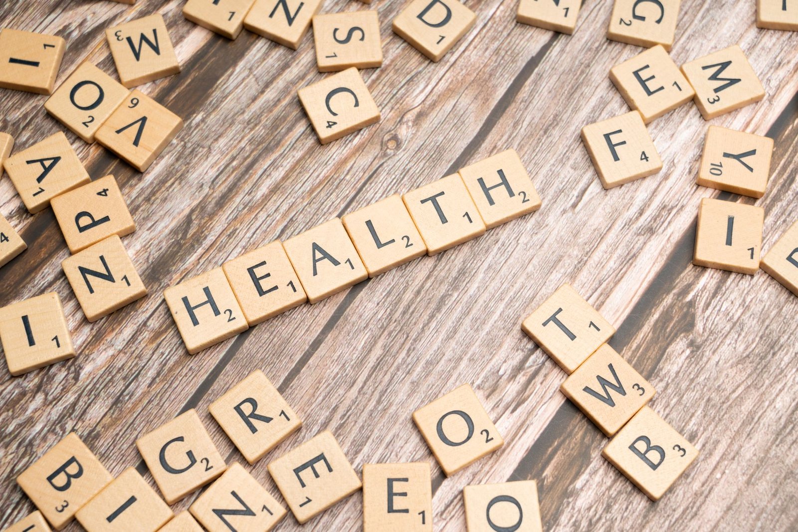 Scrabble tiles spelling 'HEALTH' on wooden surface, symbolizing wellness. — Dental Insurance and Individual Health Plans