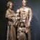 Bronze sculpture of a family with historical clothing, depicting a father, mother, and two children.
