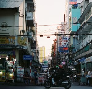 Colorful busy street scene in Cần Thơ, Vietnam with vibrant signs and people. — How to Box in Pipes for a Clean and Tidy Fini