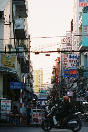 Colorful busy street scene in Cần Thơ, Vietnam with vibrant signs and people. — How to Box in Pipes for a Clean and Tidy Fini