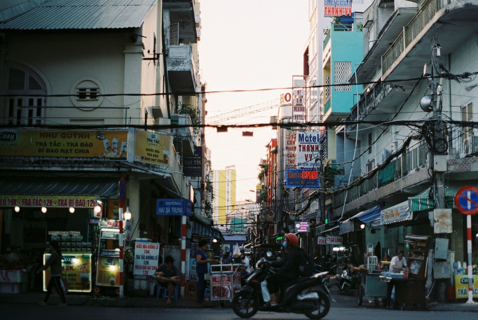Colorful busy street scene in Cần Thơ, Vietnam with vibrant signs and people. — How to Box in Pipes for a Clean and Tidy Fini