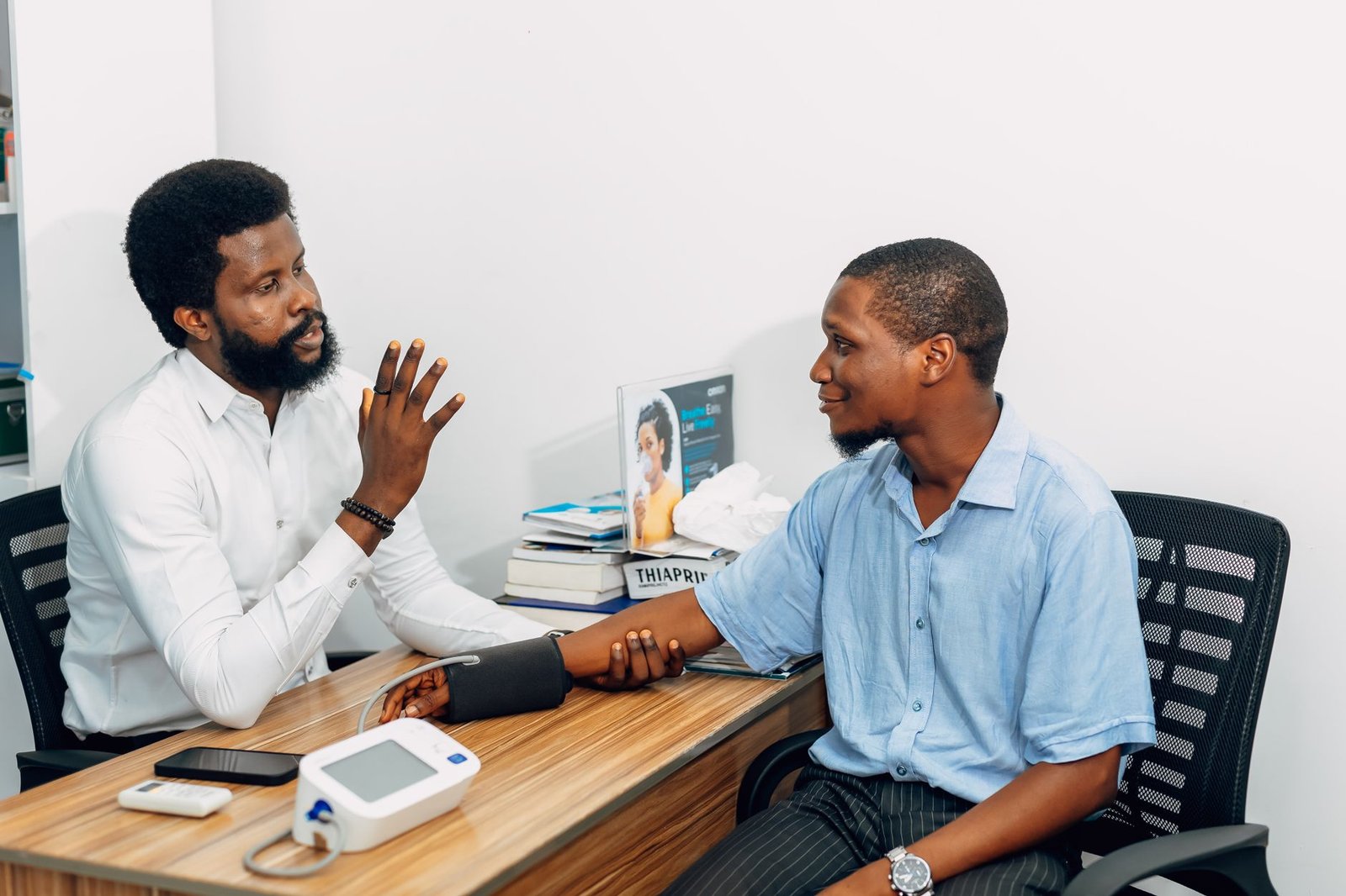 A medical professional consults with a patient during a blood pressure checkup in Lagos, Nigeria. — How to make your dog smar
