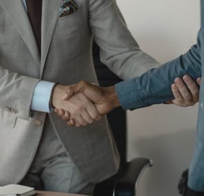 Image of a professional handshake between two businessmen in an office setting. — How White Label SEO Packages Can Transform