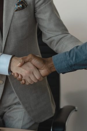 Image of a professional handshake between two businessmen in an office setting. — How White Label SEO Packages Can Transform