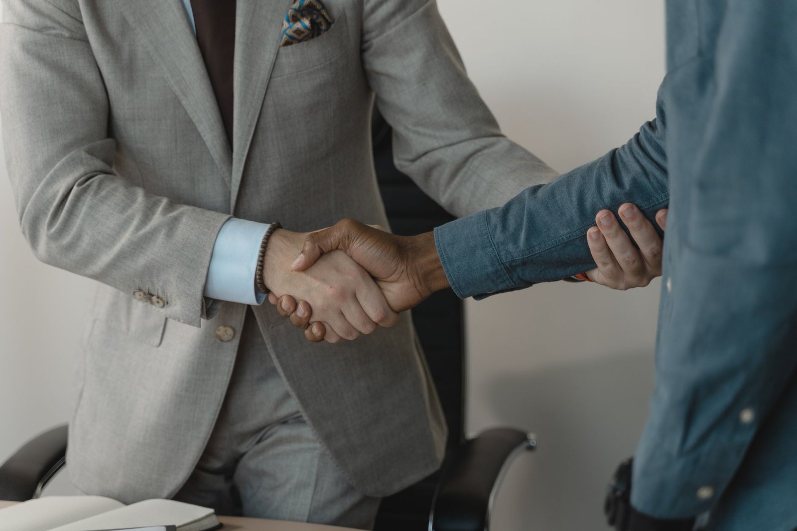 Image of a professional handshake between two businessmen in an office setting. — How White Label SEO Packages Can Transform