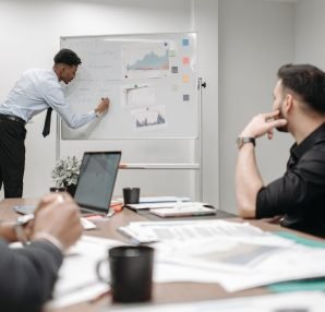 Colleagues in a business meeting discussing data and strategies at the office. — Nangs Delivery Services Tailored to Your Req