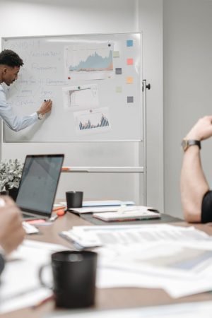 Colleagues in a business meeting discussing data and strategies at the office. — Nangs Delivery Services Tailored to Your Req