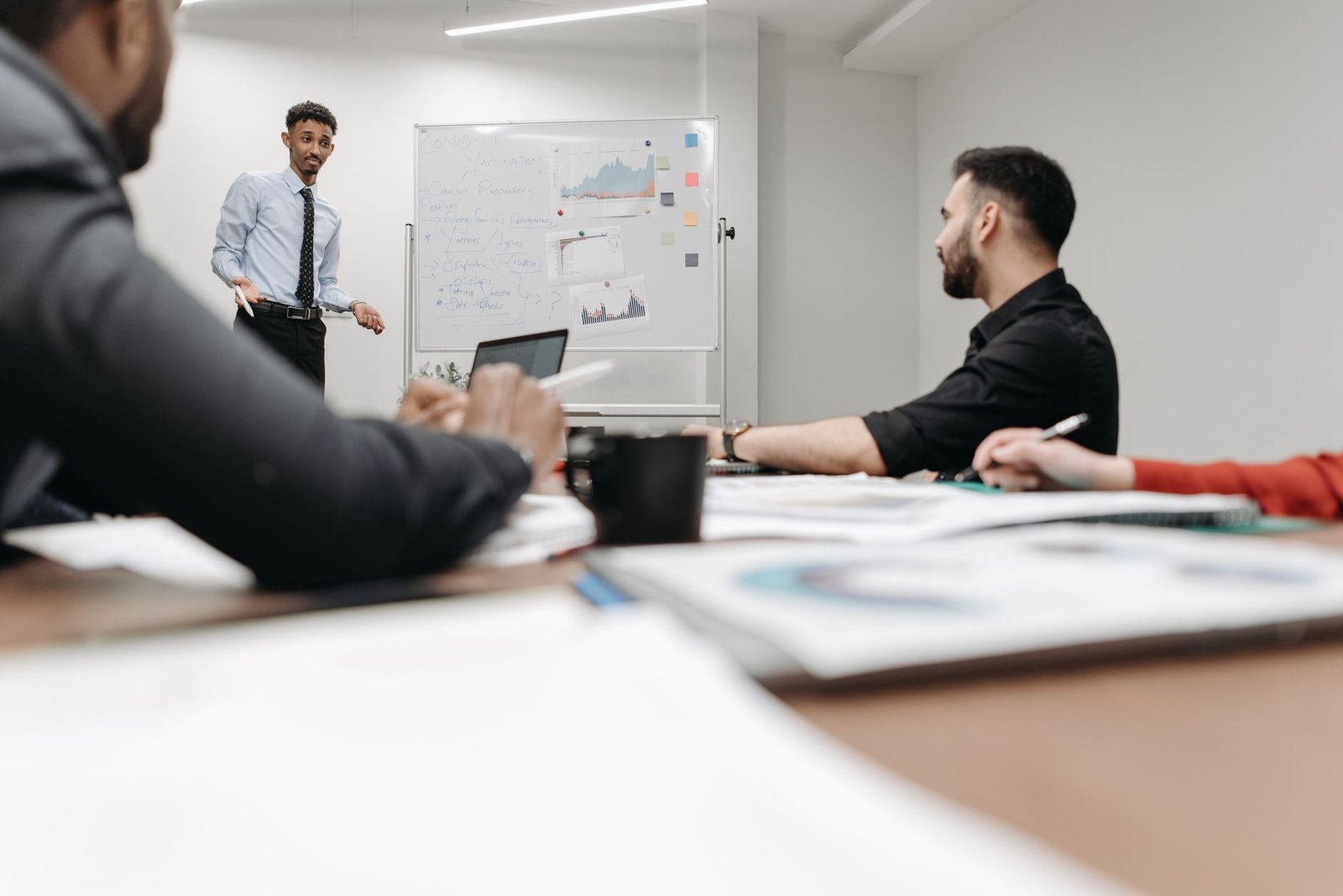 Corporate team during a presentation in an office setting, featuring discussions and planning. — Room Alba Jobs: Flexible Par