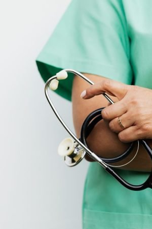 Close-up of a healthcare worker holding a stethoscope, showcasing medical professionalism. — Take care of your teeth in the r