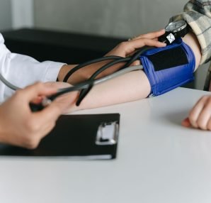 A healthcare worker uses a sphygmomanometer to check a patient's blood pressure in a medical office. — The Usefulness of Onli