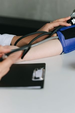 A healthcare worker uses a sphygmomanometer to check a patient's blood pressure in a medical office. — The Usefulness of Onli