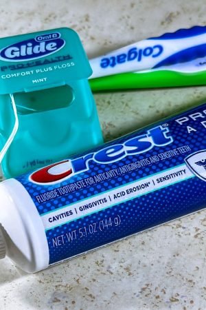 Close-up of dental care items including toothbrush, floss, and toothpaste for oral hygiene. — Understand Your Deals with the