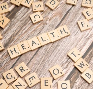 Scrabble tiles spelling 'HEALTH' on wooden surface, symbolizing wellness. — Want take a good care of your elder parents?