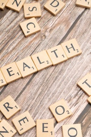 Scrabble tiles spelling 'HEALTH' on wooden surface, symbolizing wellness. — Want take a good care of your elder parents?