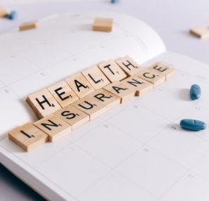 Scrabble tiles spelling 'Health Insurance' on a calendar with pills. — What are NAD+ supplements? Does it work?and how to mak