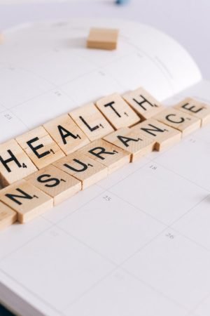 Scrabble tiles spelling 'Health Insurance' on a calendar with pills. — What are NAD+ supplements? Does it work?and how to mak