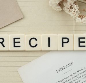 Elegant flat lay featuring recipe letter tiles, dried flowers, and notes on lined paper. — What Foods Fight Bad Breath?