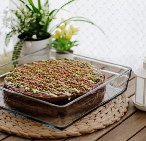 A beautifully decorated homemade chocolate cake topped with pistachios in a cozy setting. — What Foods Improve Eyesight Natur