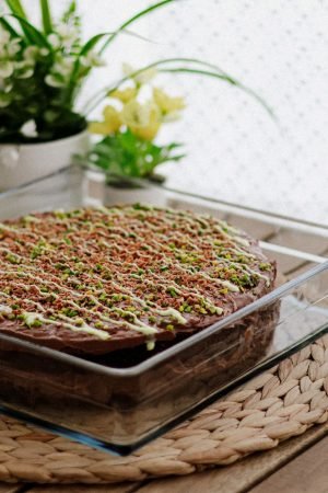 A beautifully decorated homemade chocolate cake topped with pistachios in a cozy setting. — What Foods Improve Eyesight Natur