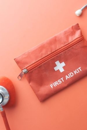 Medical tools including a stethoscope and first aid kit on a pink surface, perfect for healthcare themes. — What You Know Abo