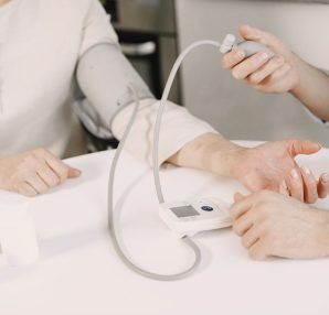 Close-up of blood pressure measurement at home highlighting healthcare equipment. — Why you might need a facelift surgery?