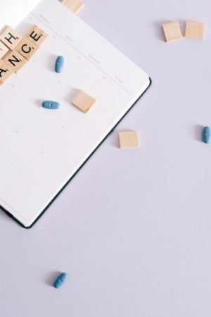 Flat lay of health insurance concept with planner and pills. — Why You Need Colonic Irrigation