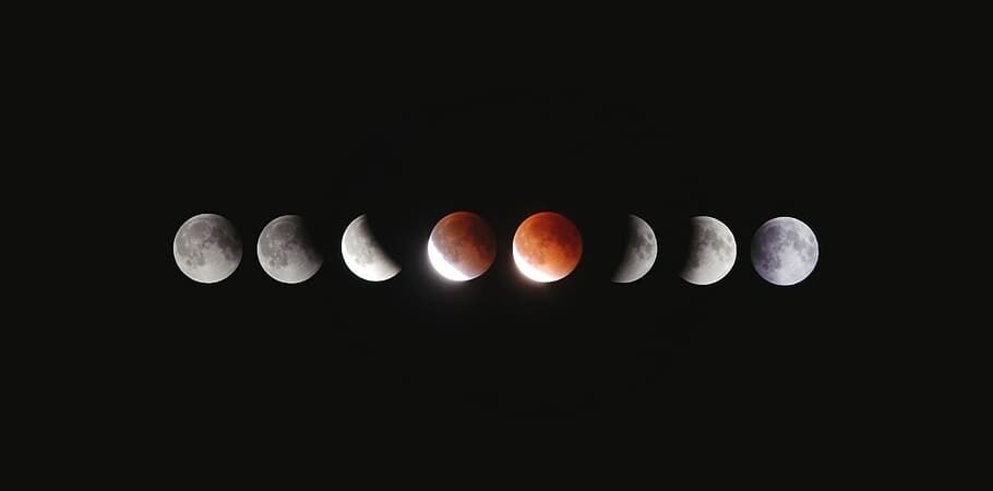 Phases of the moon against a dark background